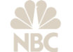 The image shows the NBC logo, featuring a stylized peacock with its feathers fanned out above the letters NBC. The logo is in a beige or light tan color on a light background.