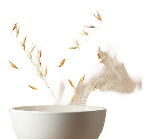 A white bowl with oats and oat grains swirling above it against a plain white background, creating a sense of motion.