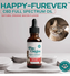 A bottle of Full-Spectrum (1,000mg) Happy-Furever™ Calming Oil - For Cats sits on a white platform. The natural bacon flavor label notes it’s non-psychoactive and veterinarian approved, featuring a cat photo above.